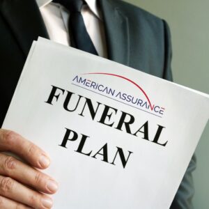 A man holding an American Assurance Funeral Planning Services guide.