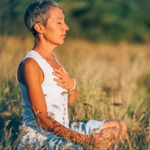 A woman meditating in a field. Do you really need Health Insurance? Having it will give you the peace of mind you need.