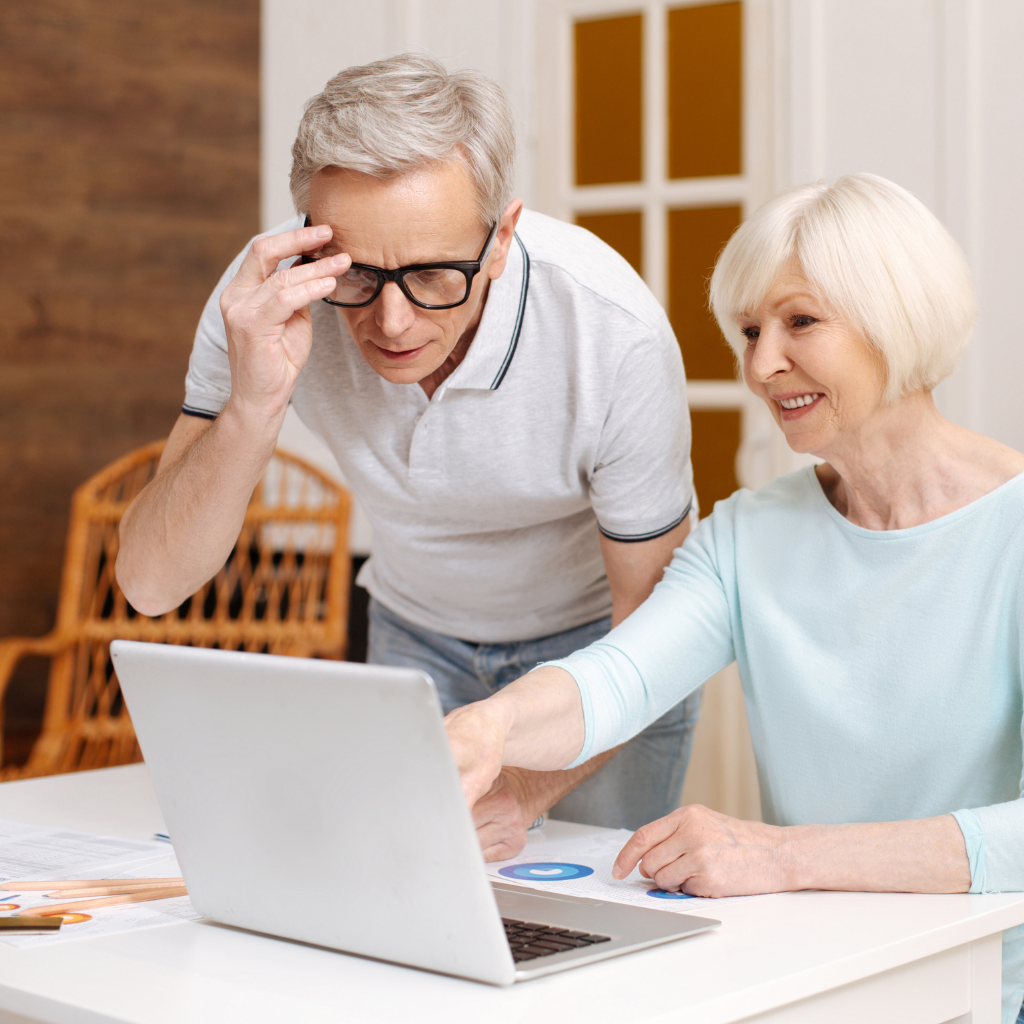 Elderly checking on insurance requirements in their laptop