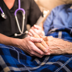 Hands of the care giver and the elder patient, holding hands