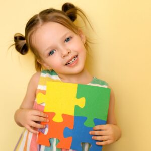 What benefits can you claim if you have an autistic child? : A girl with an autism colors puzzle